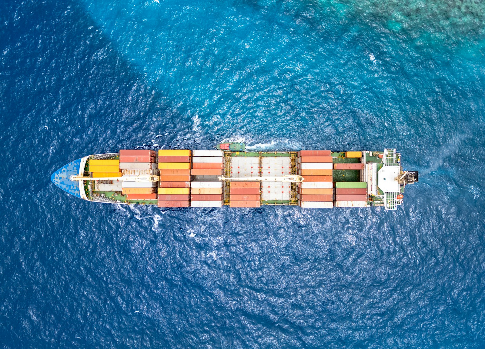 An aerial view of a cargo ship in the ocean