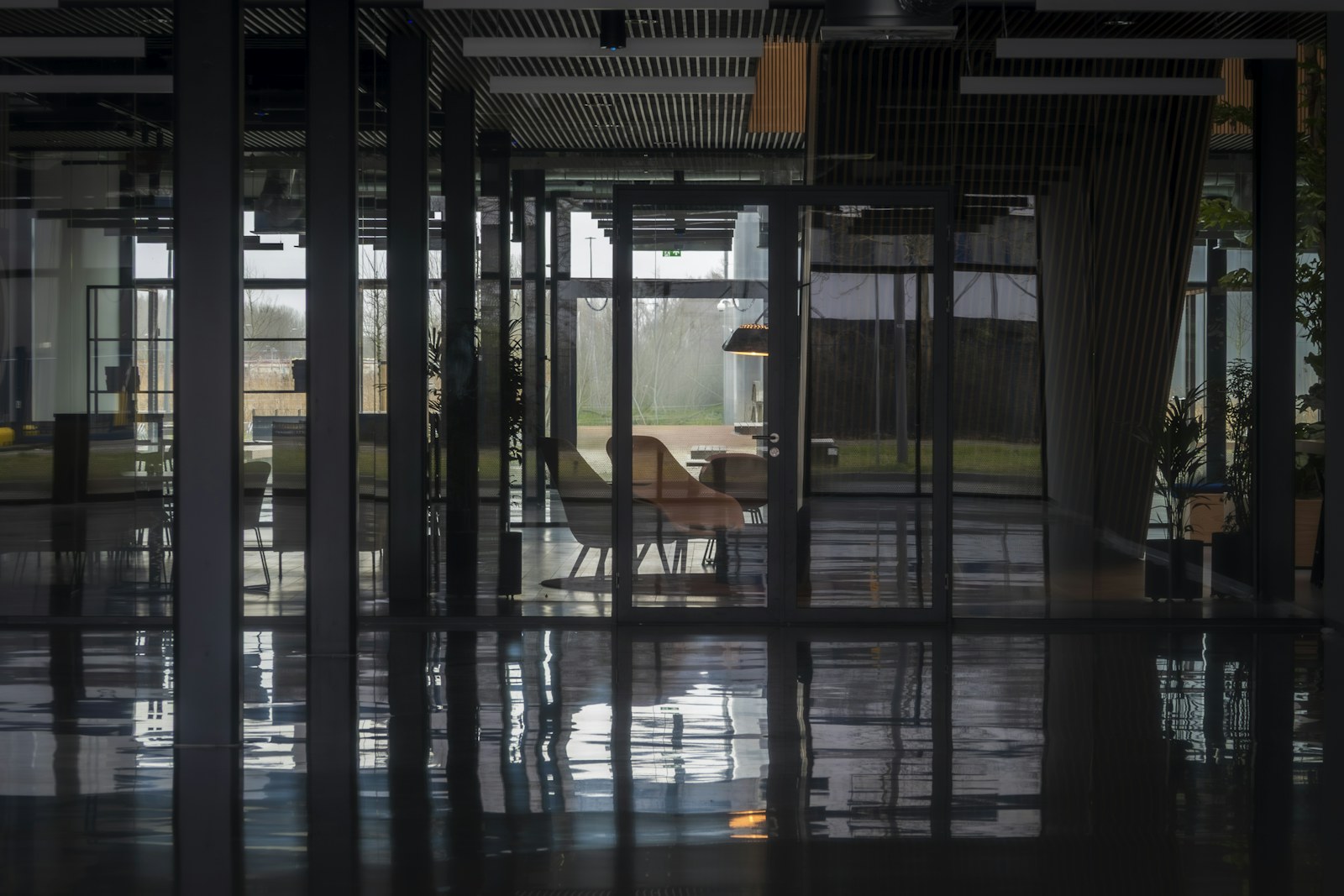 Modern office interior with glass walls and reflections