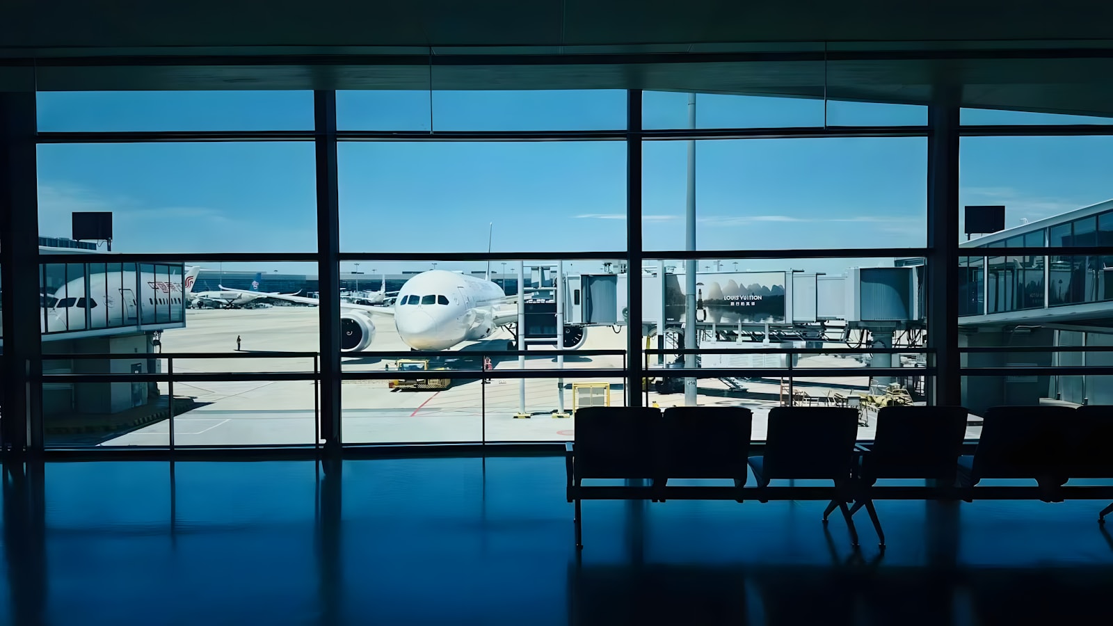 Airplane at airport gate viewed through window