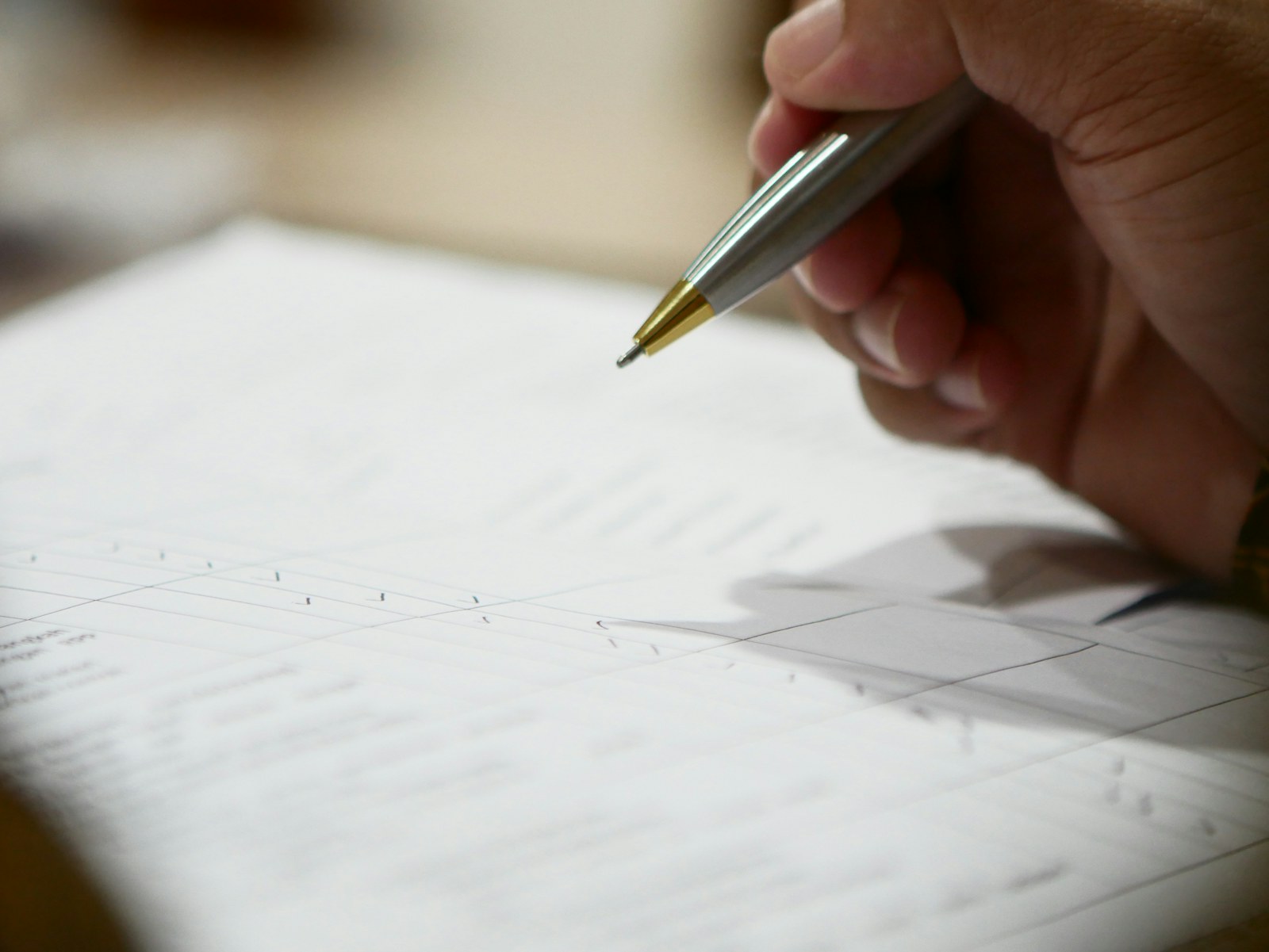a hand holding a pen