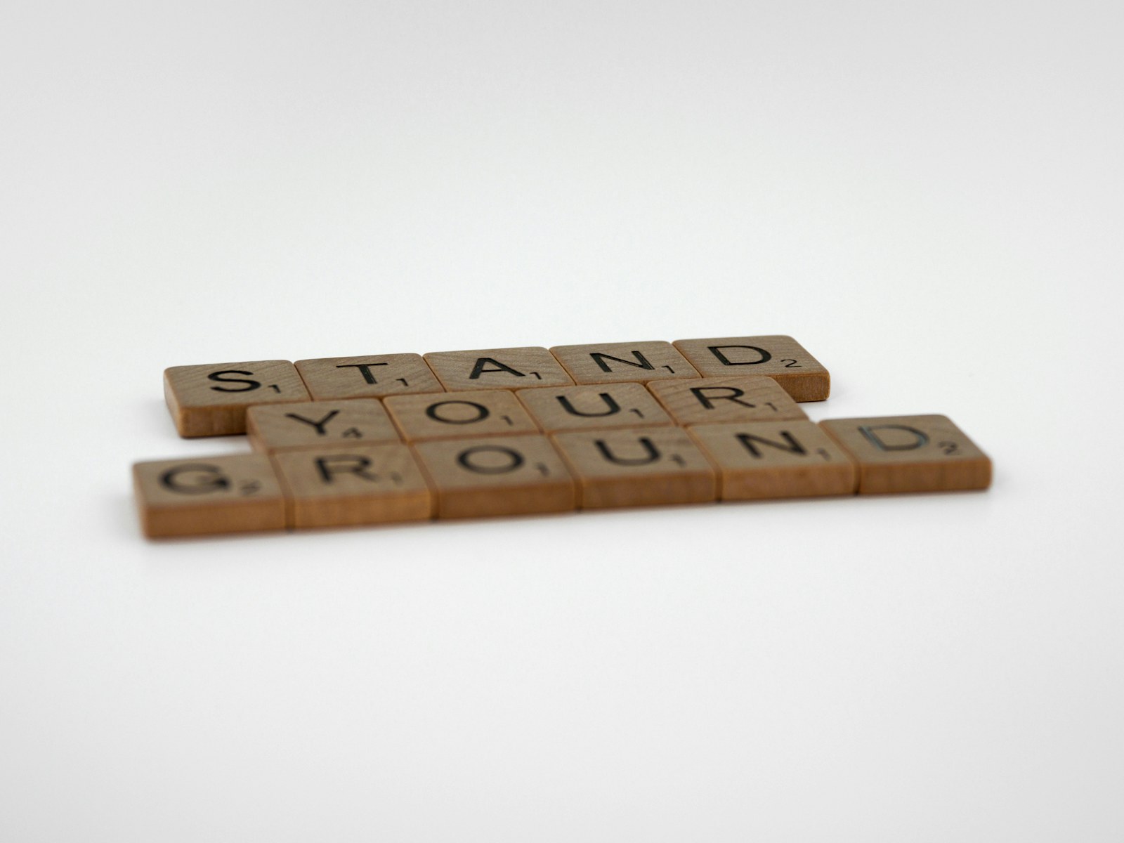 a couple of scrabble tiles sitting on top of a table
