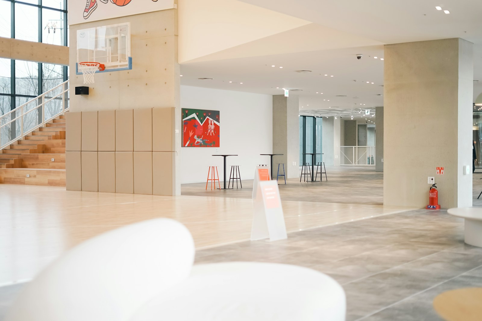 a large room with a basketball hoop in the middle of it