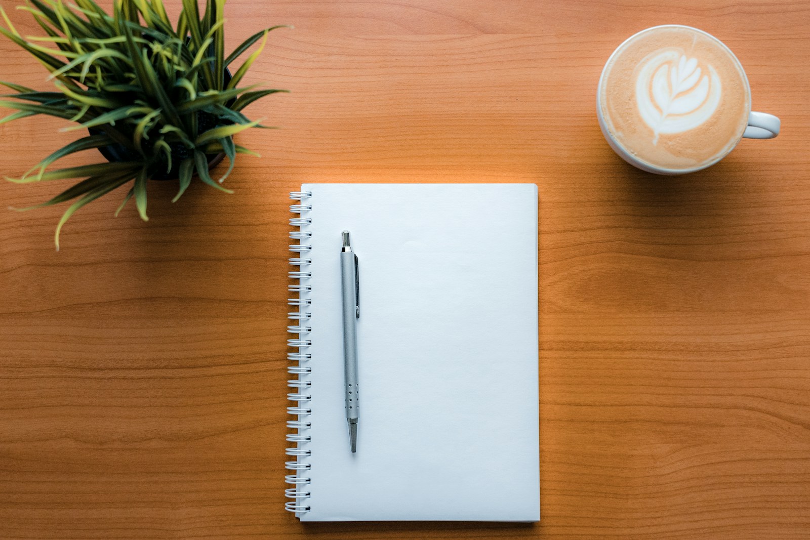 a pen and a cup of coffee