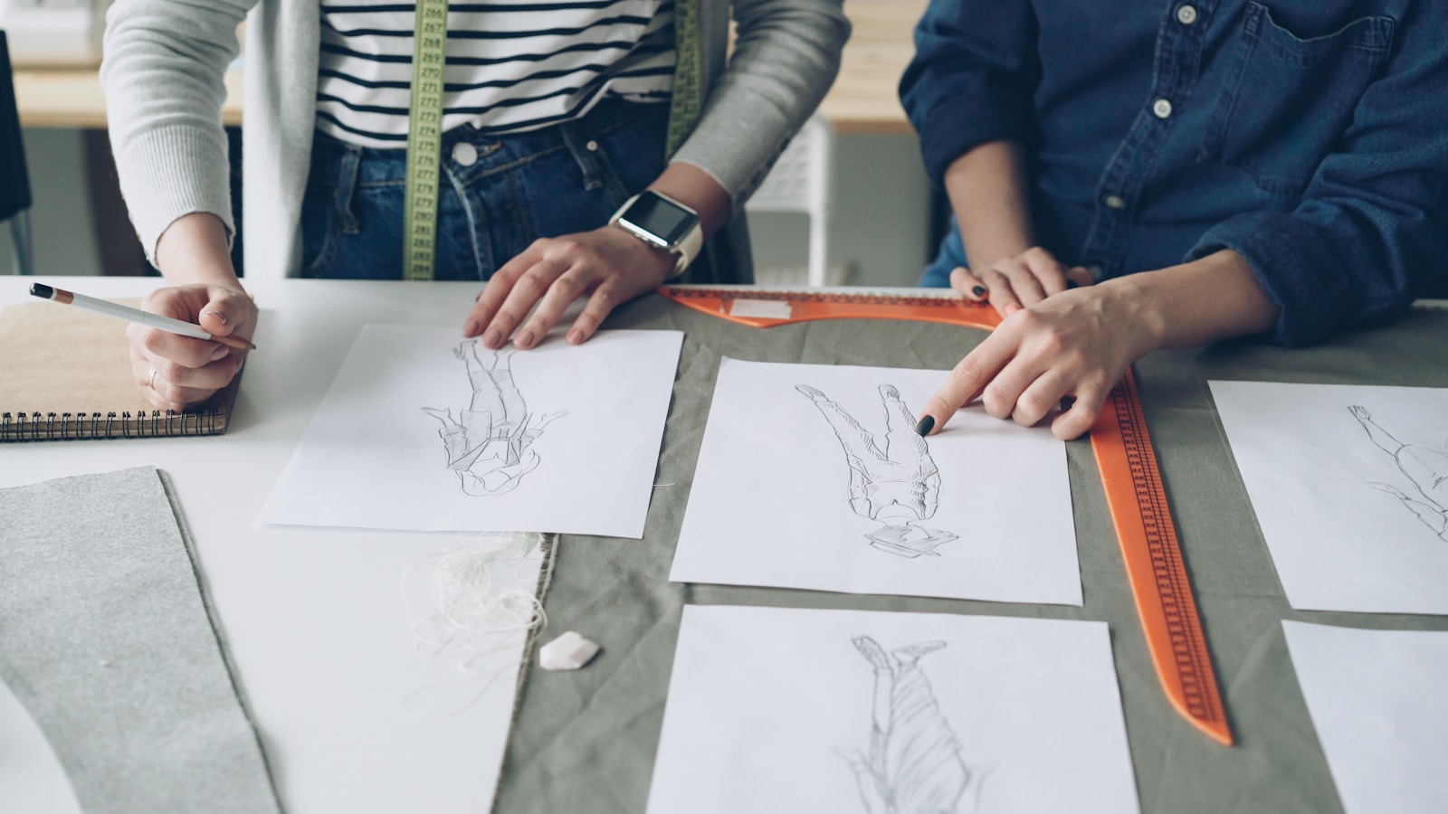Designers collaborate on fashion sketches and plans