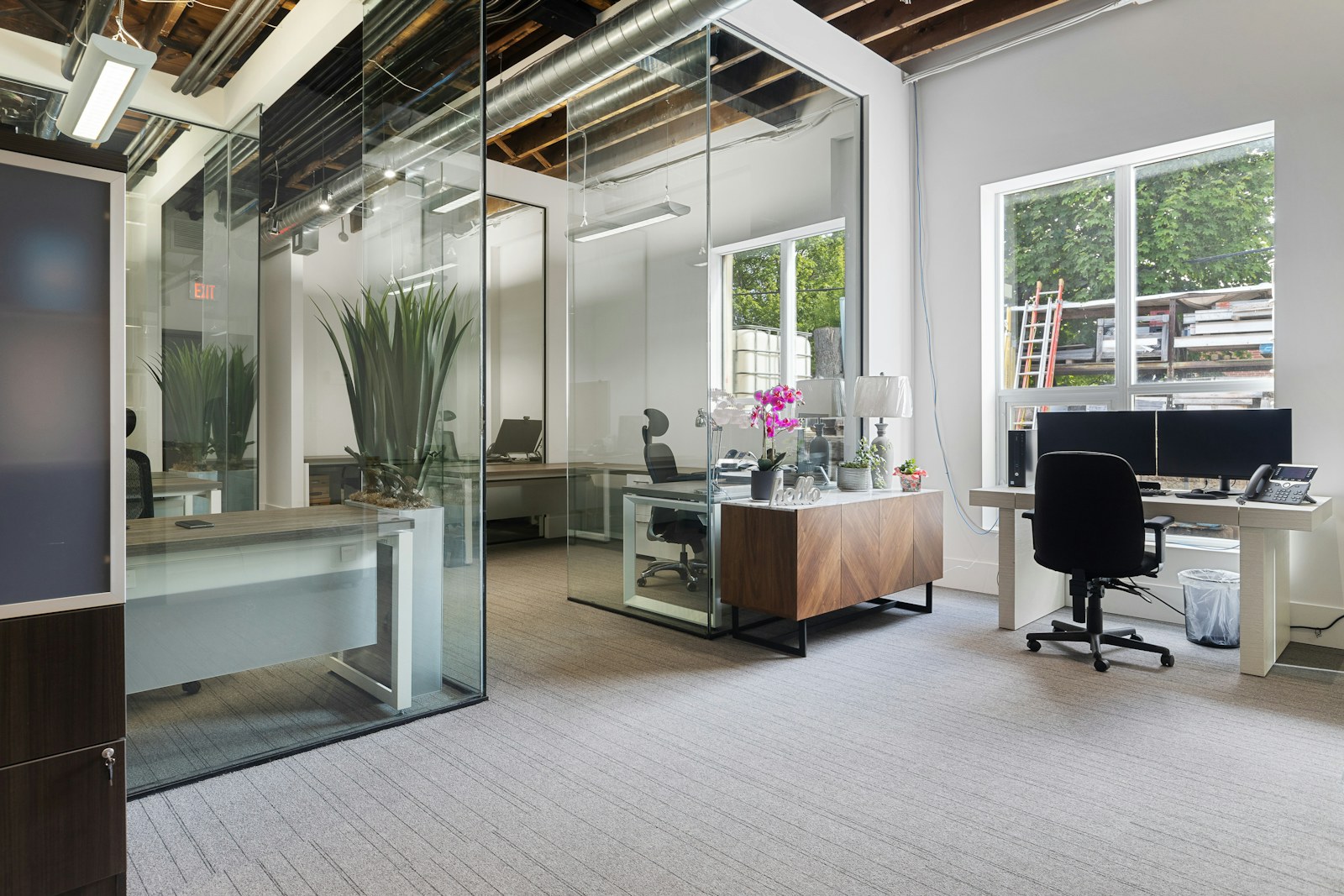 a room with a desk and chairs