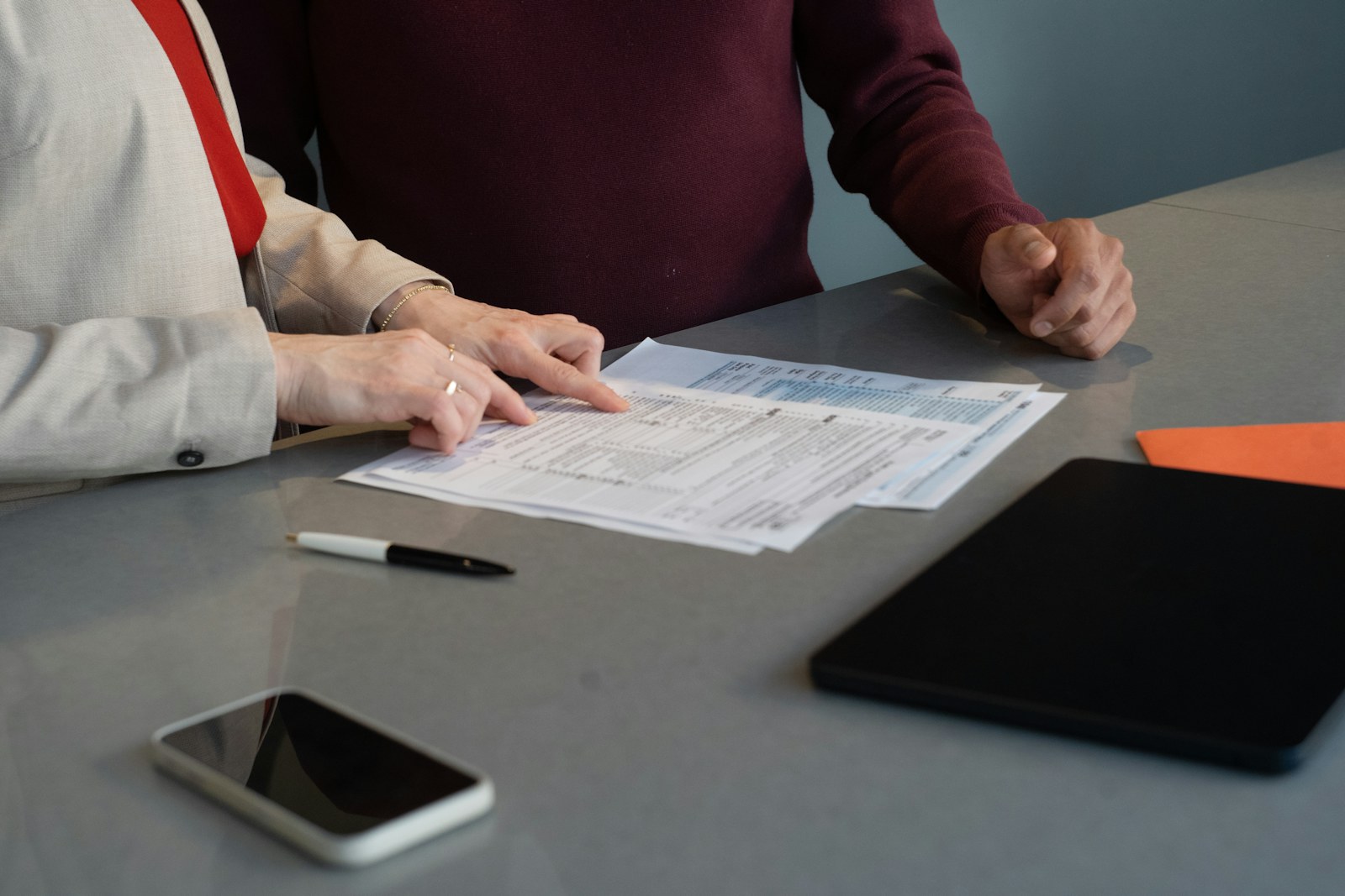Two people reviewing documents at a table