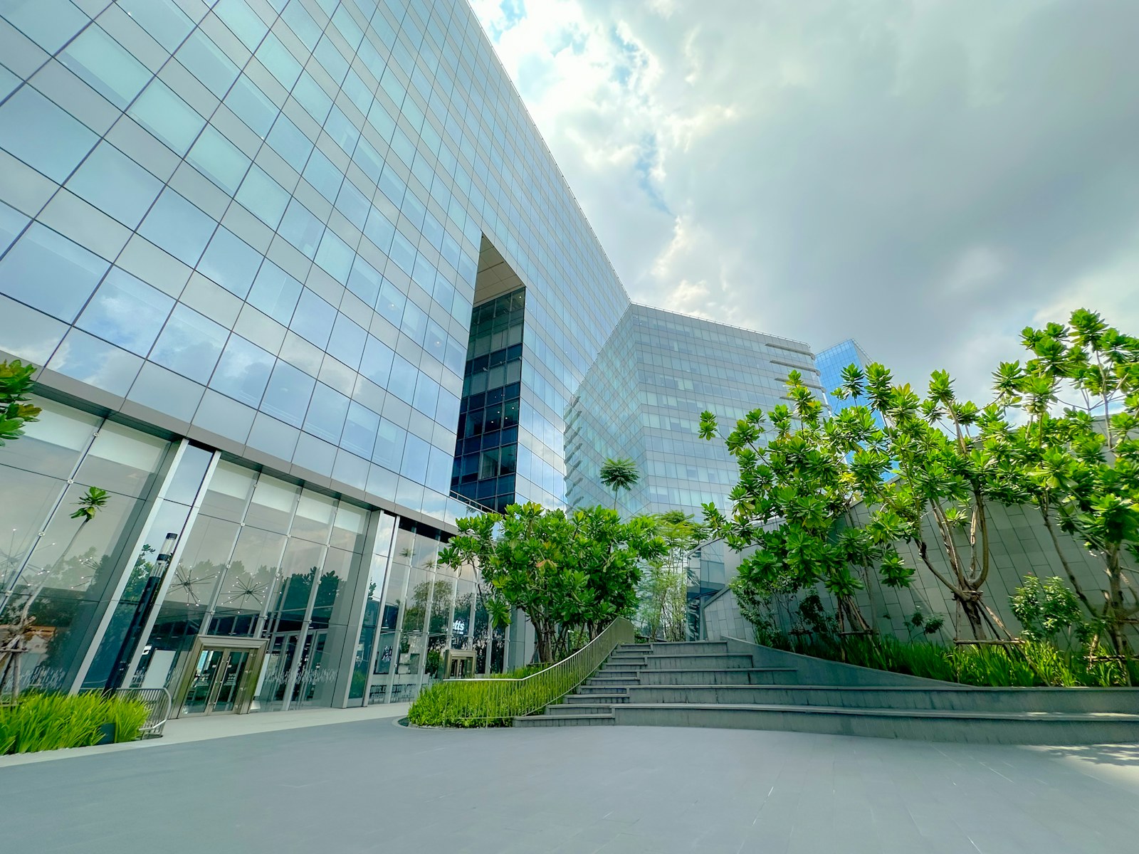 Modern glass building with green landscaping