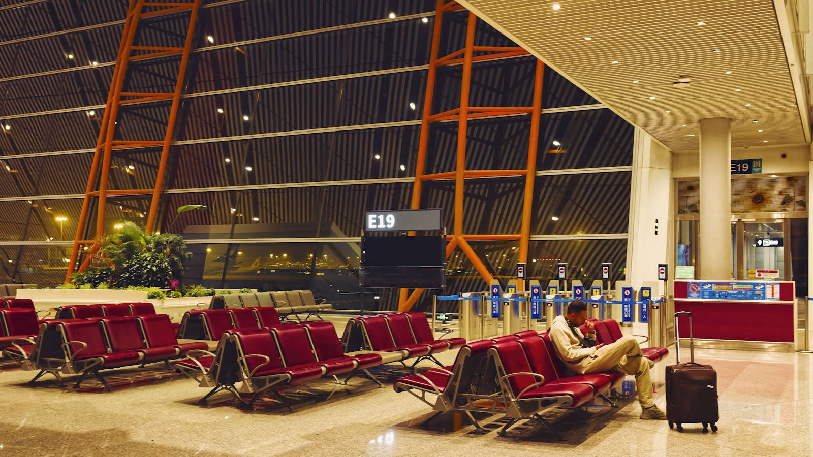 Man sitting in empty airport waiting area