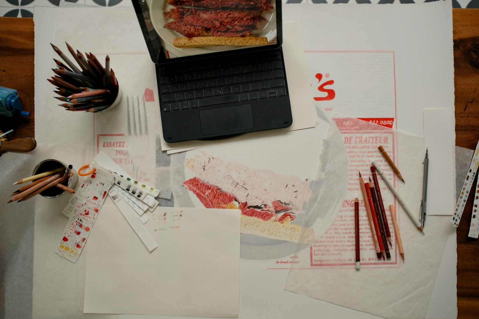 Art supplies and a sandwich on a table