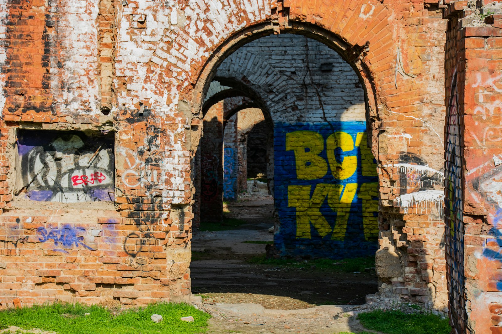 Graffiti-covered brick arches of an abandoned building
