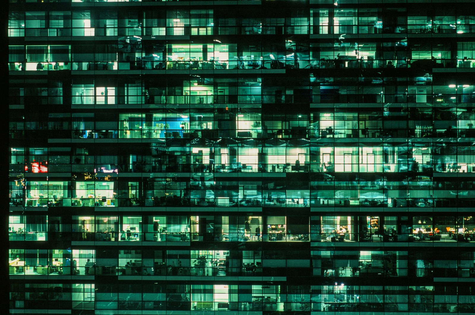 a very tall building with lots of windows at night