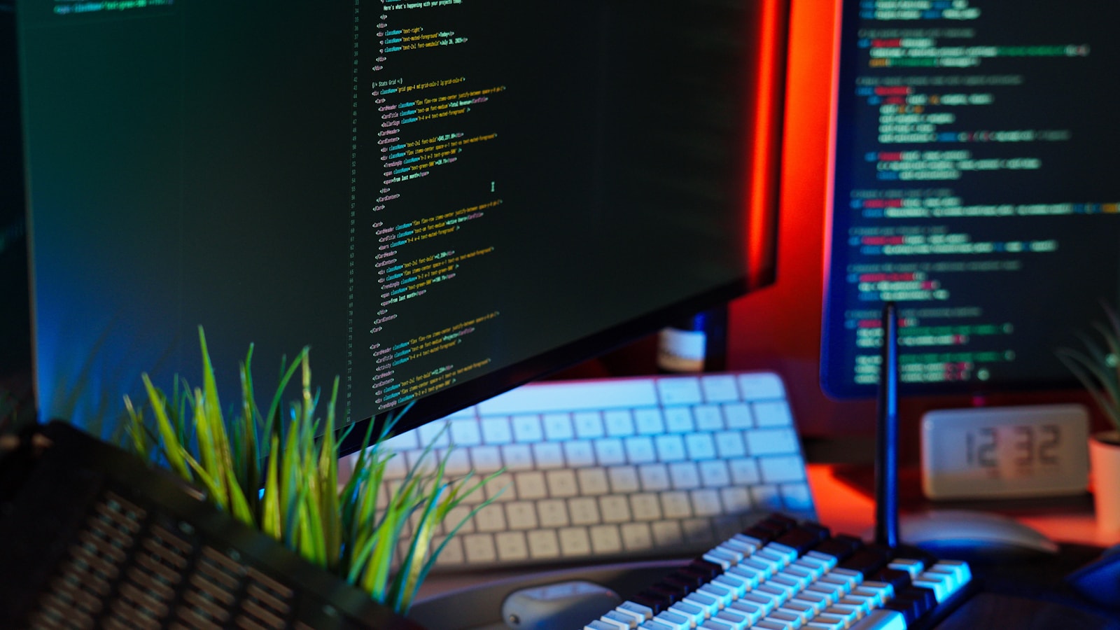 Screens display coding text, representing programming work