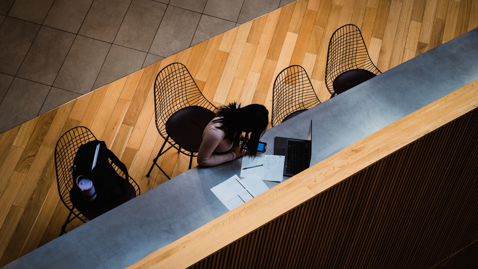 Woman resting head on desk at a table