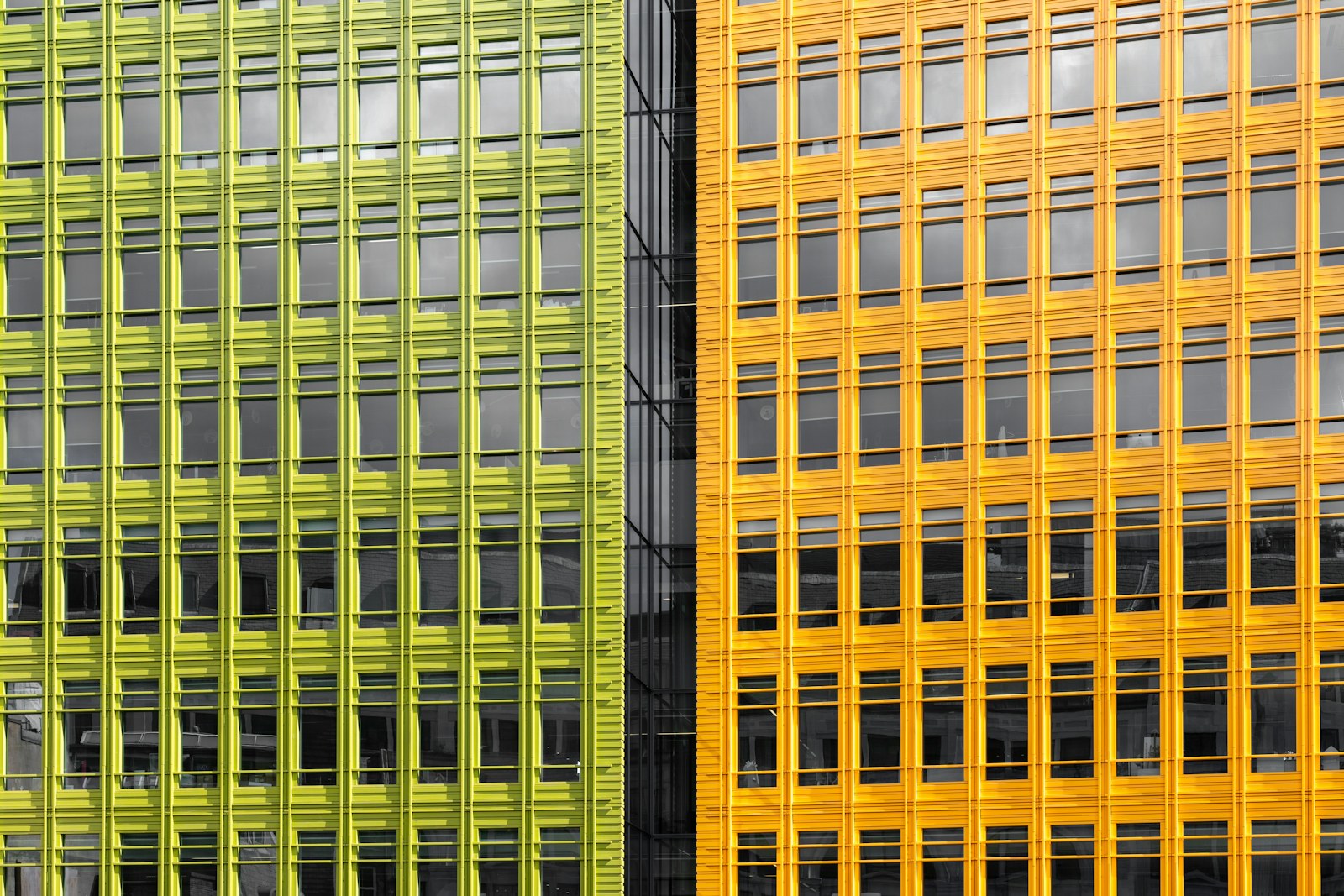 a yellow and a green building side by side