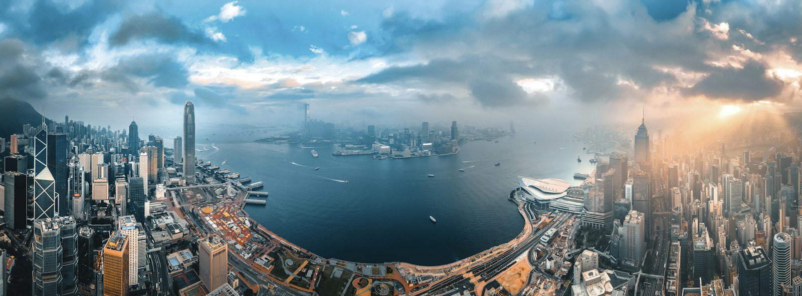 An aerial view of the Hong Kong Island skyline and Victoria Harbour at low sun