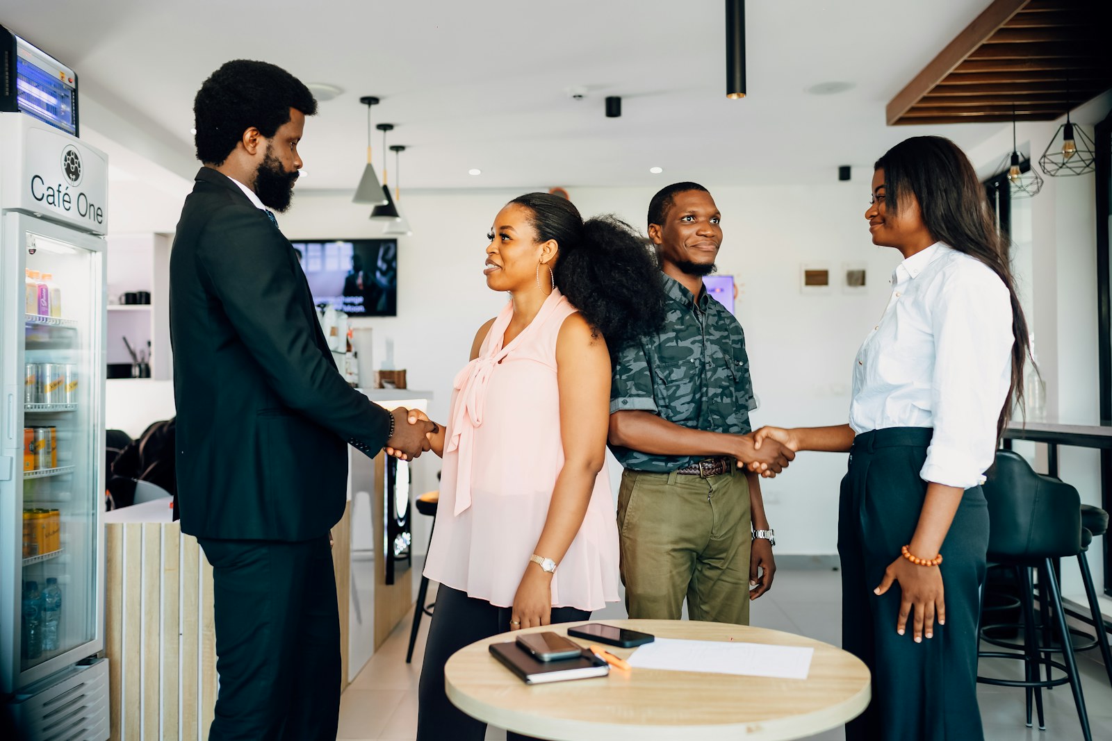 A group of people shaking hands in a room