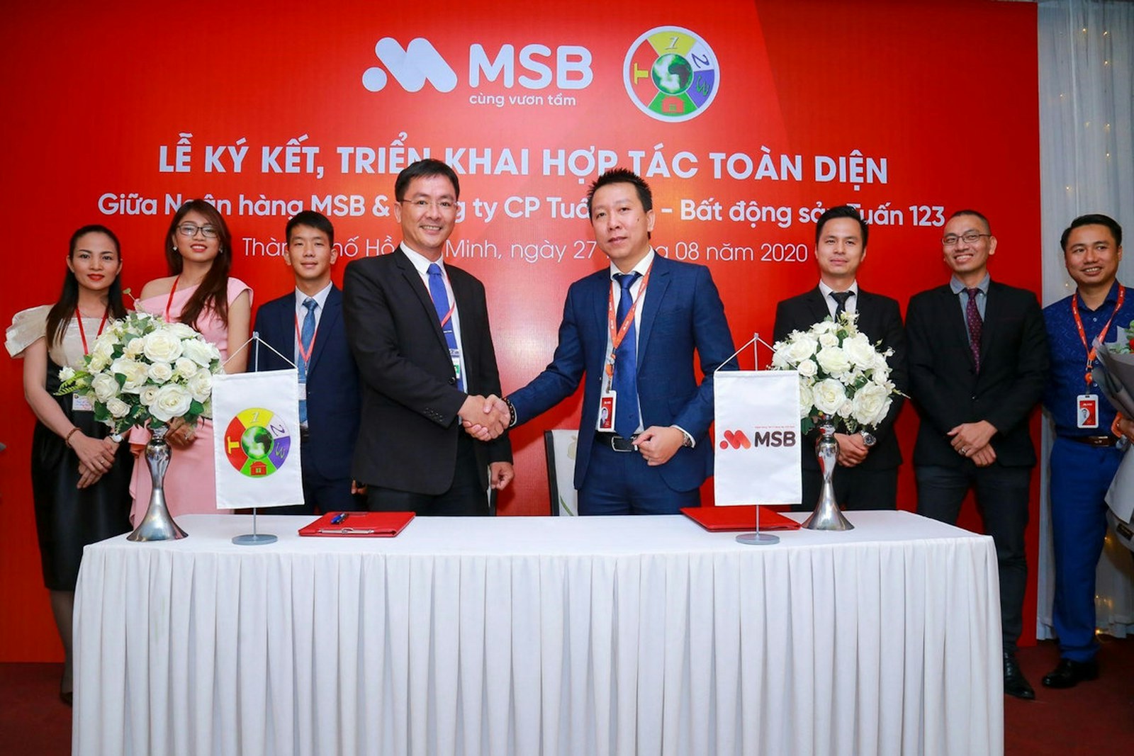 Two businessmen shaking hands at a signing ceremony event