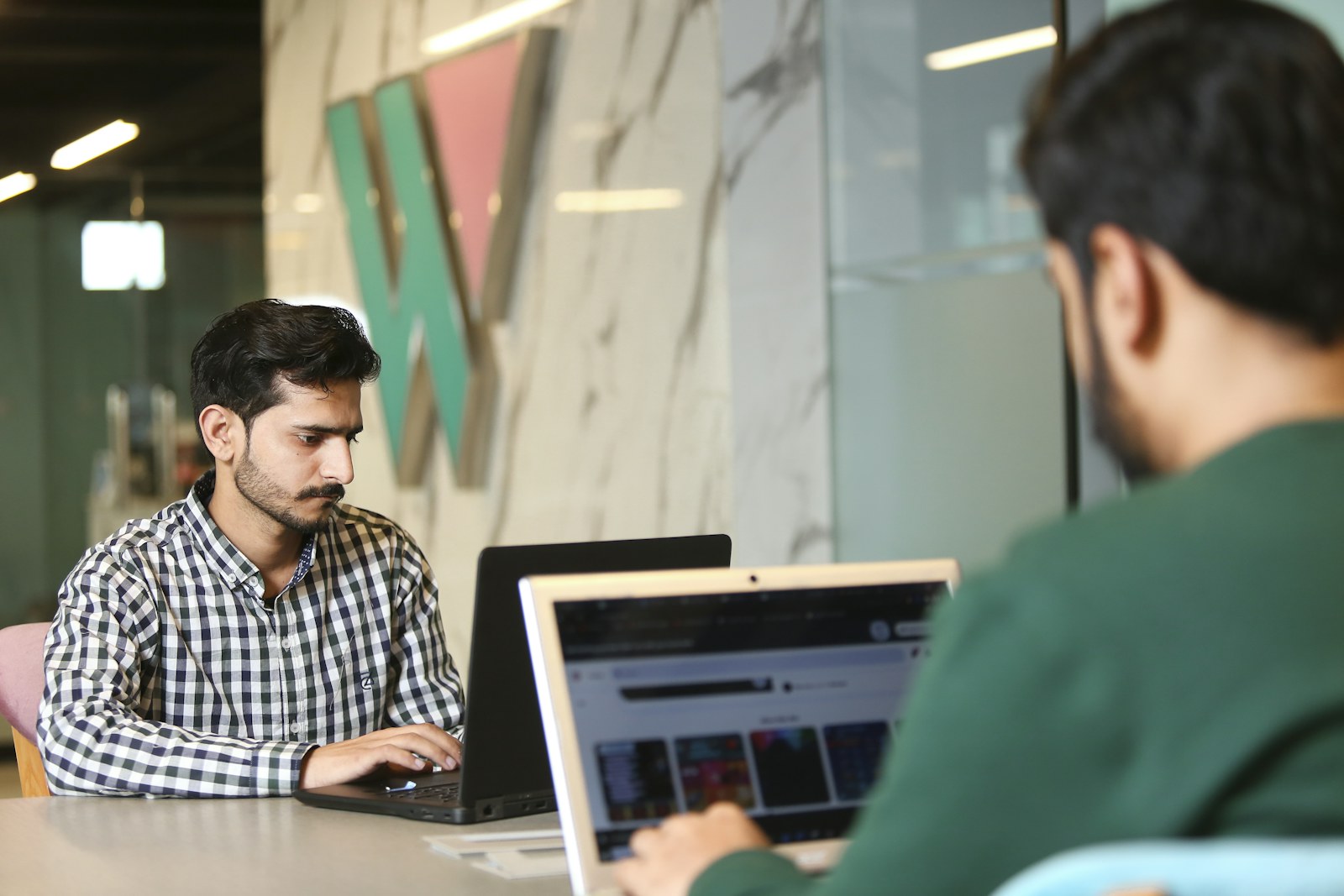 a man sitting in front of a laptop computer