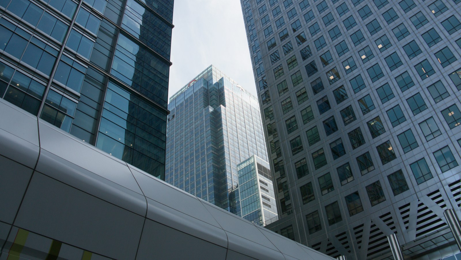 Modern glass and steel skyscrapers with a walkway