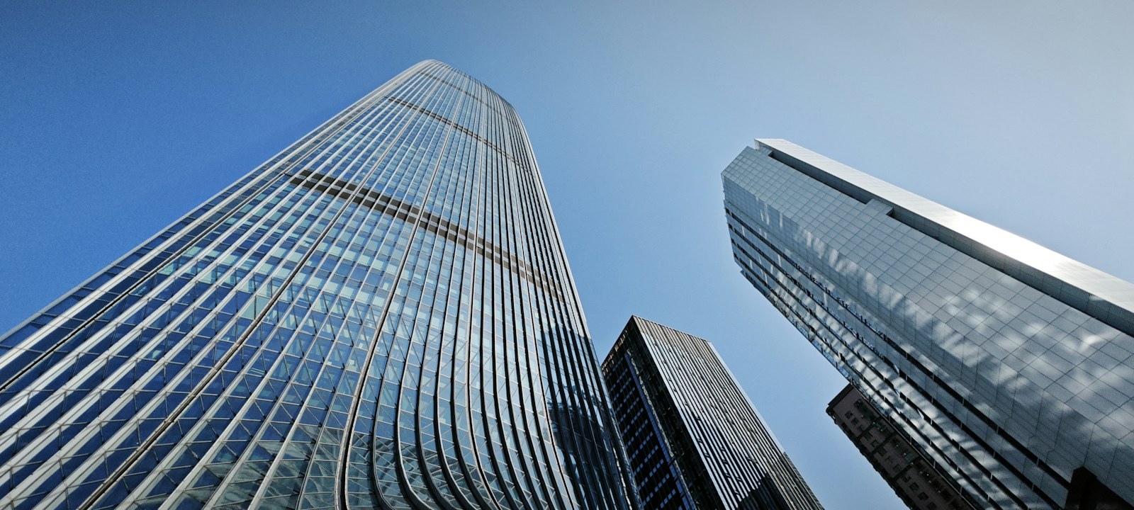Modern glass skyscrapers against a clear blue sky