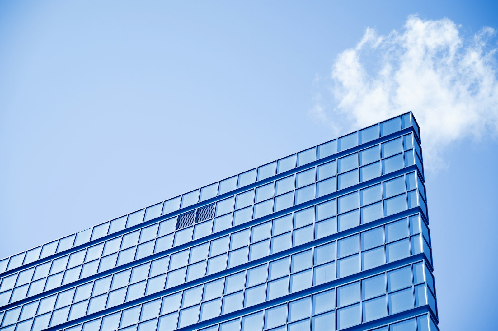 white and blue glass walled high rise building