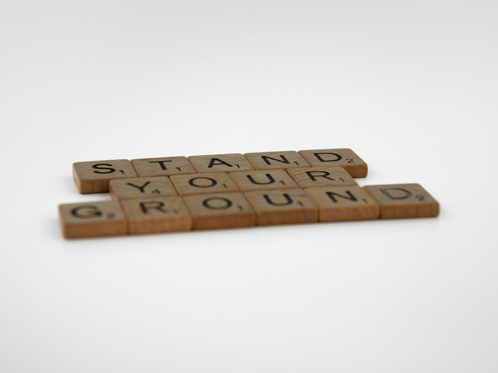 a couple of scrabble tiles sitting on top of a table