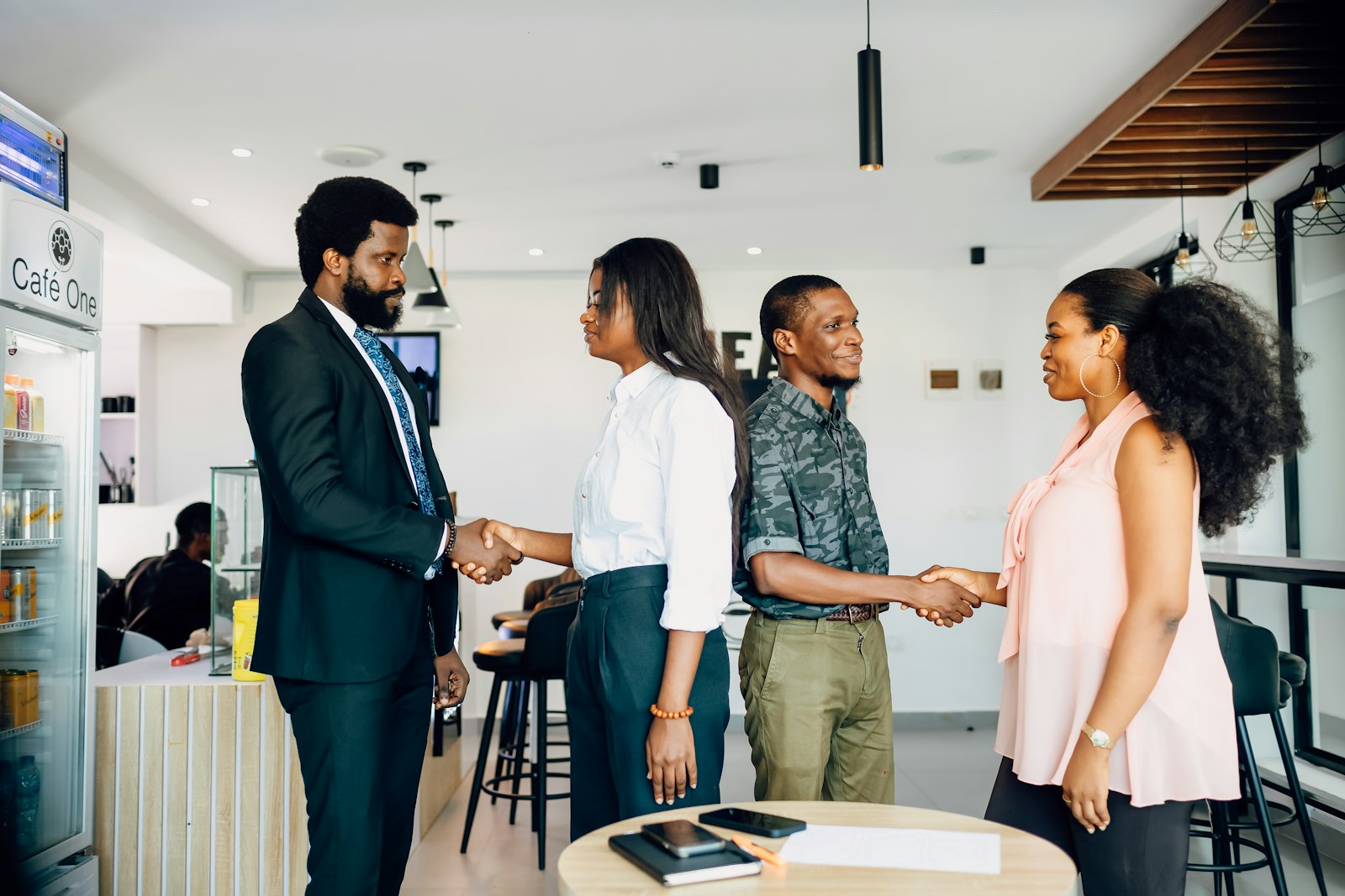 A group of people shaking hands in a room