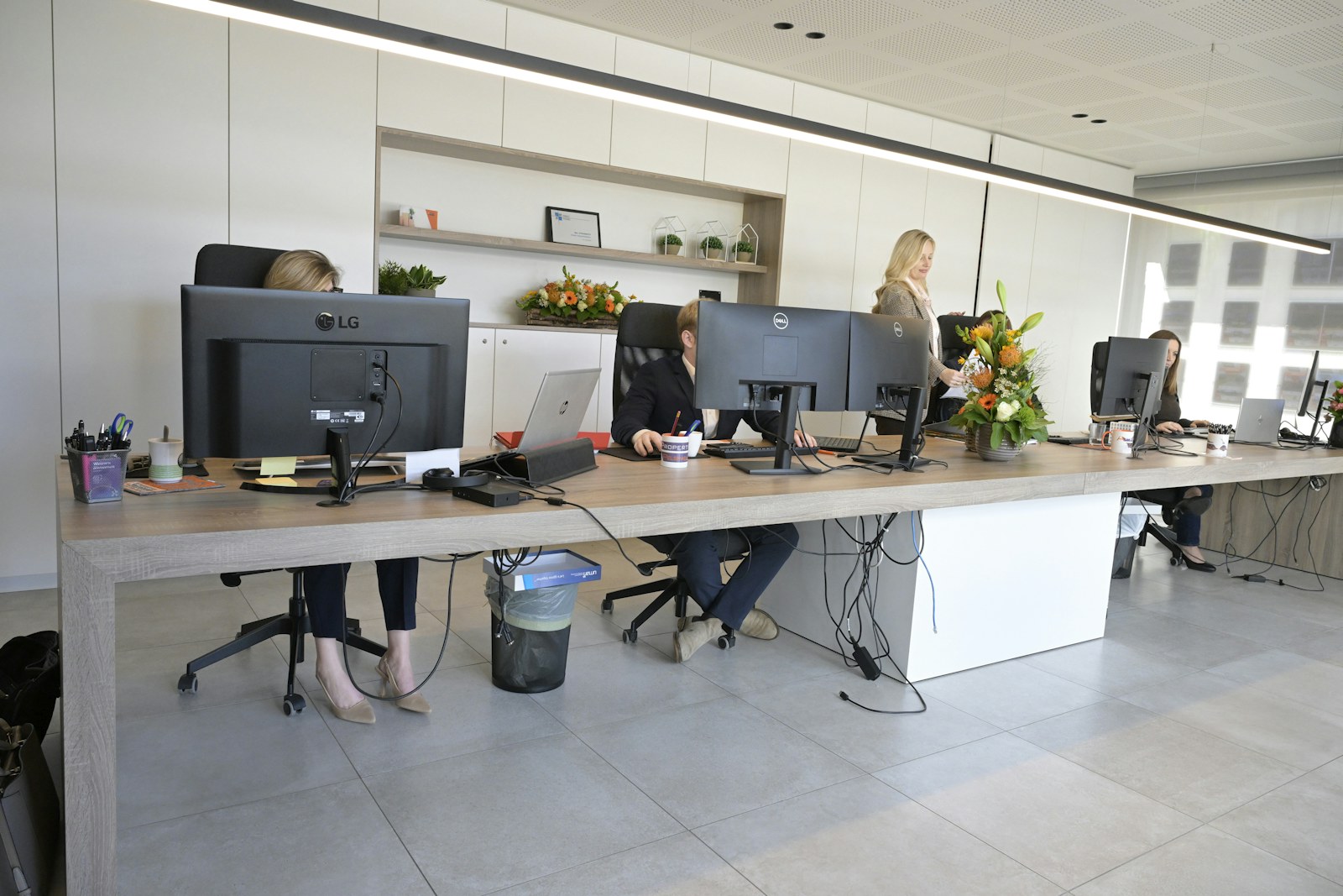 People working at desks in a modern open-plan office